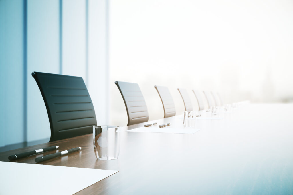 A row of empty office chairs in a boardroom, representing receiverships and the civil fraud services of Milosevic & Associates in Toronto.