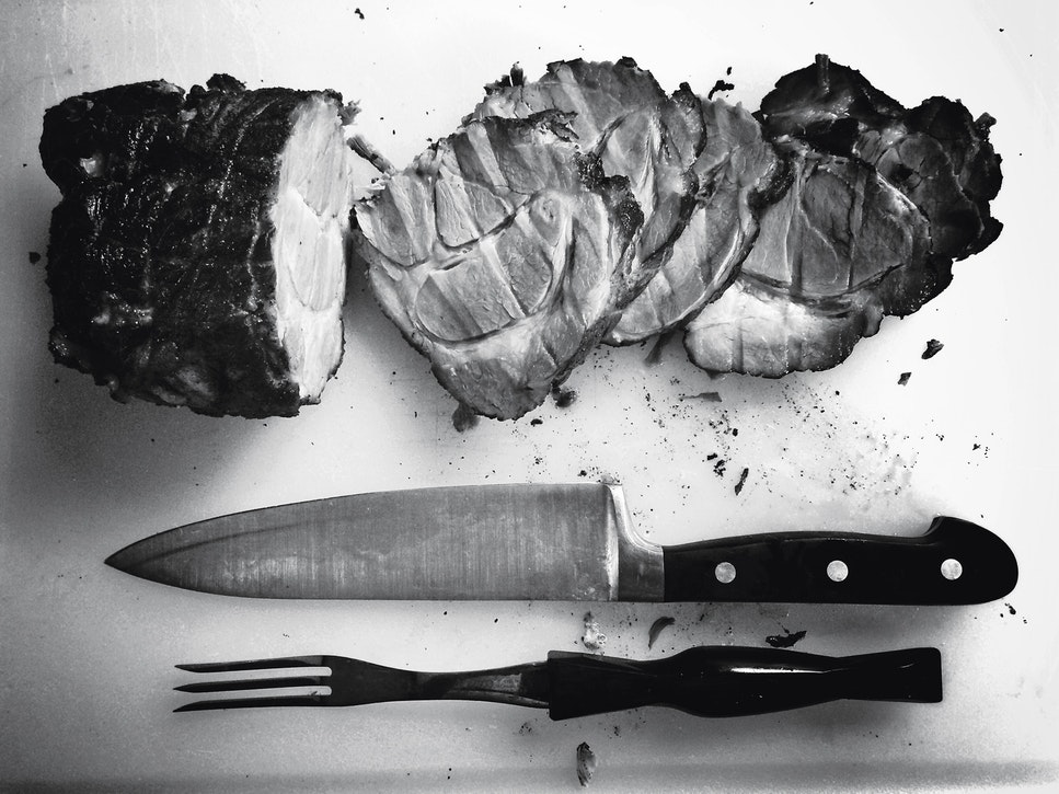 Carved meat, knife and fork