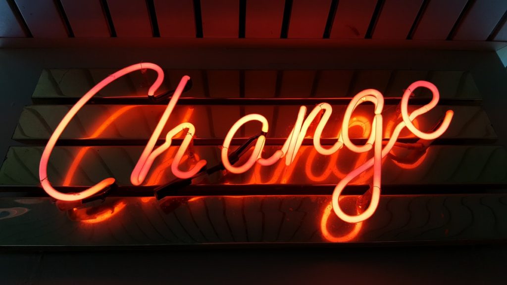 Neon change sign signifying evolving laws