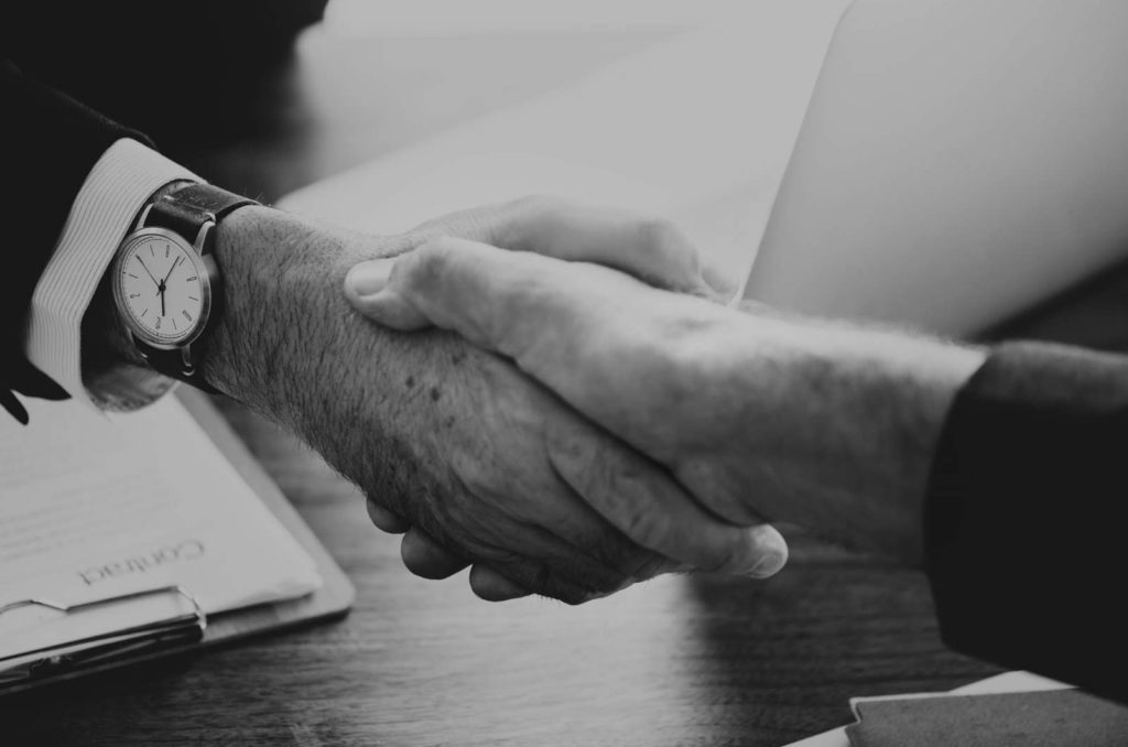 black and white close up image of a handshake