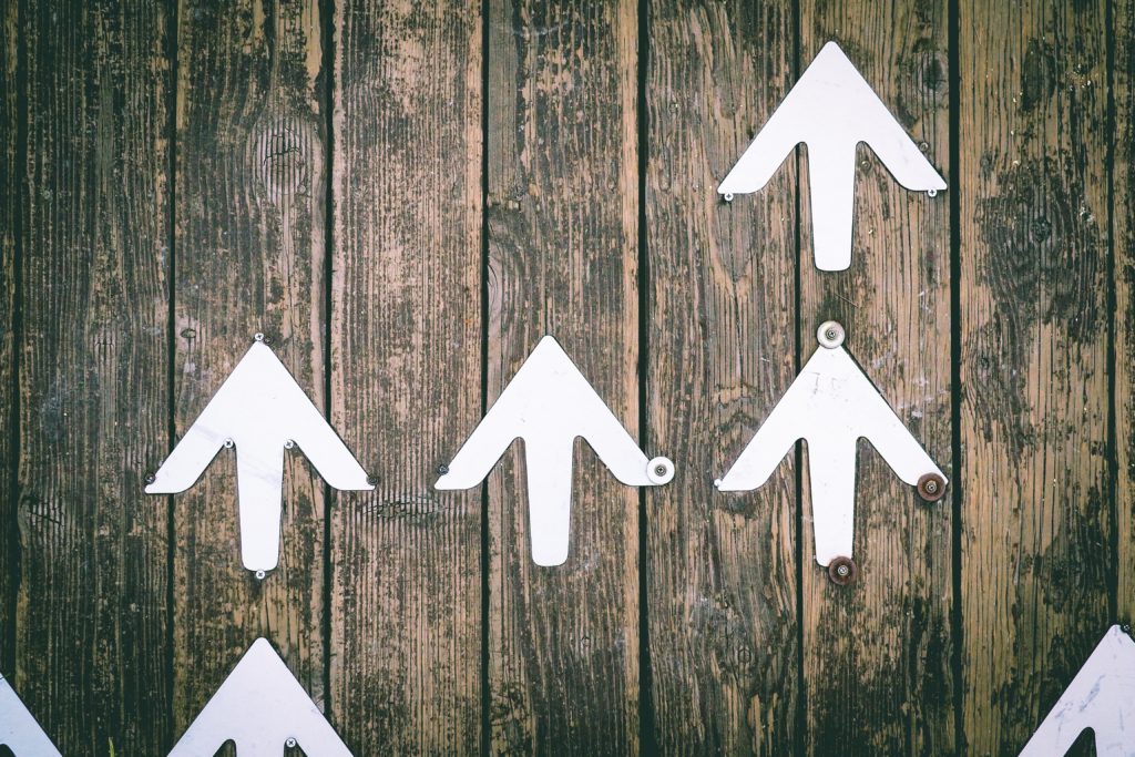 white arrows pointing up representing increases to jurisdiction for small claims court