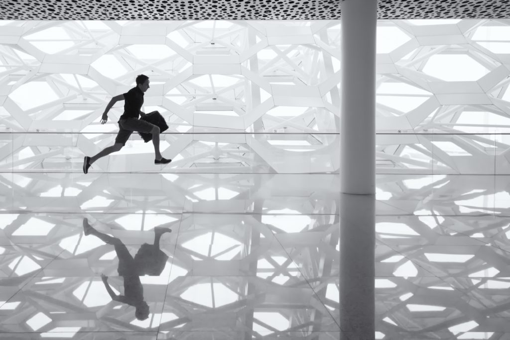 A man running with a bag, representing a person late to respond to a motion for default judgment
