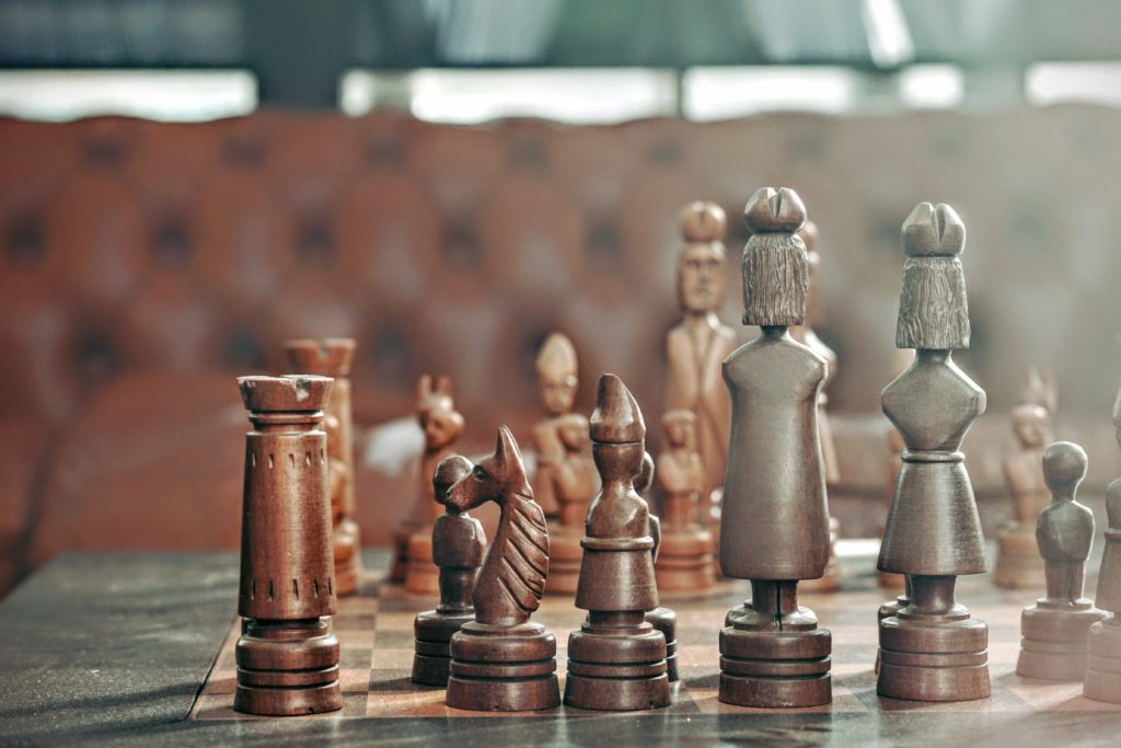 A wooden chess set representing litigation and the various moves that can be made by the participants
