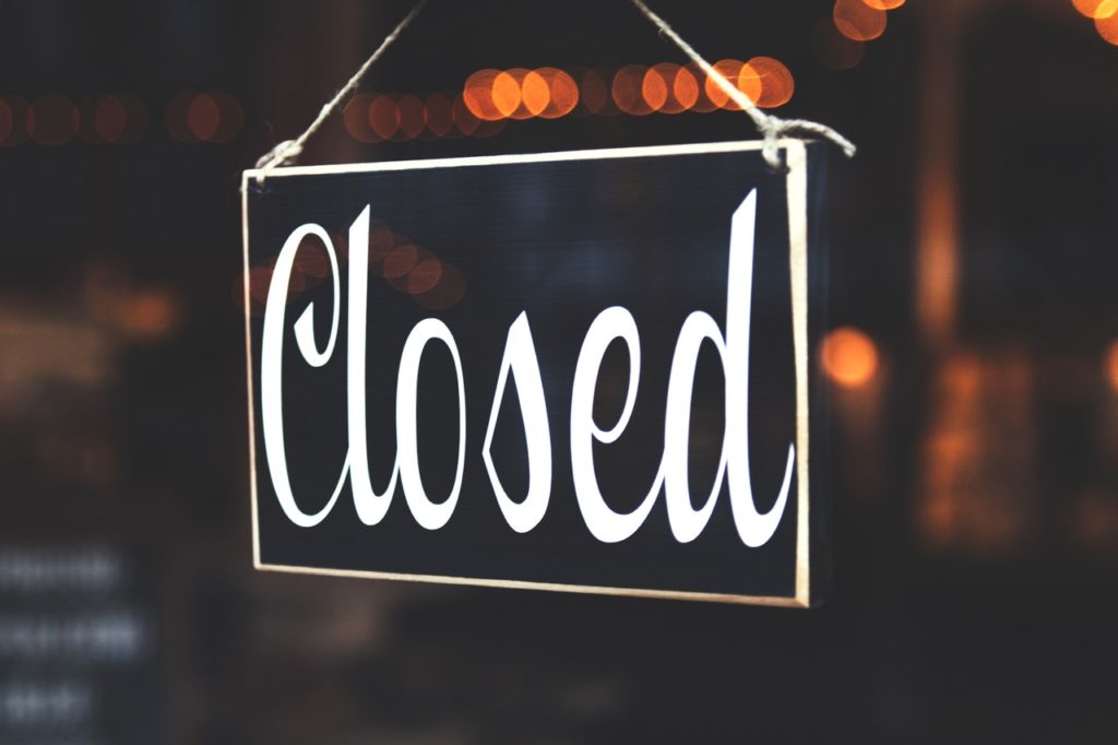 Closed sign in business window