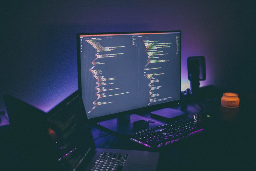 A computer monitor showing code, representing email fraud against Canadian businesses