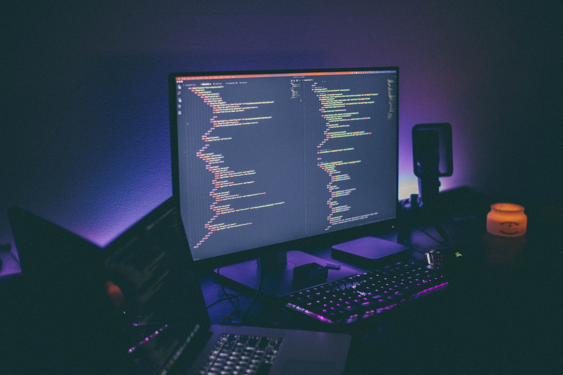 A computer monitor showing code, representing email fraud against Canadian businesses