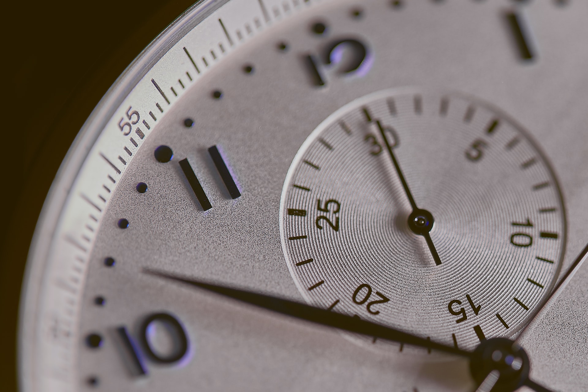 A closeup of a watch face representing time delays in litigation
