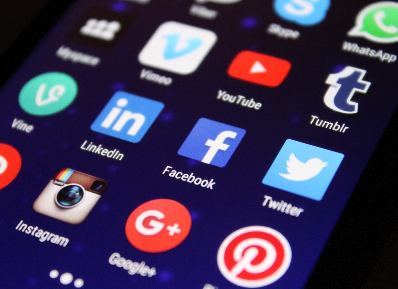 A smartphone screen showing multiple social media apps, demonstrating how easy it is to make false public claims against another person