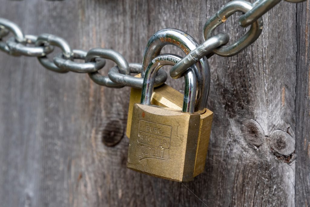 A padlocked chain, representing a commercial tenant locked out of their leased premises