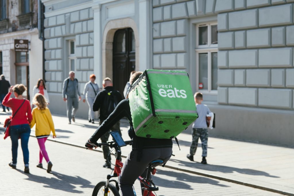 An UberEATS delivery person on a bike