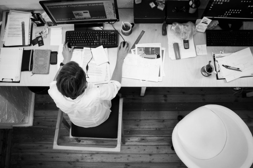 An employee at their computer, representing the potential for employee fraud