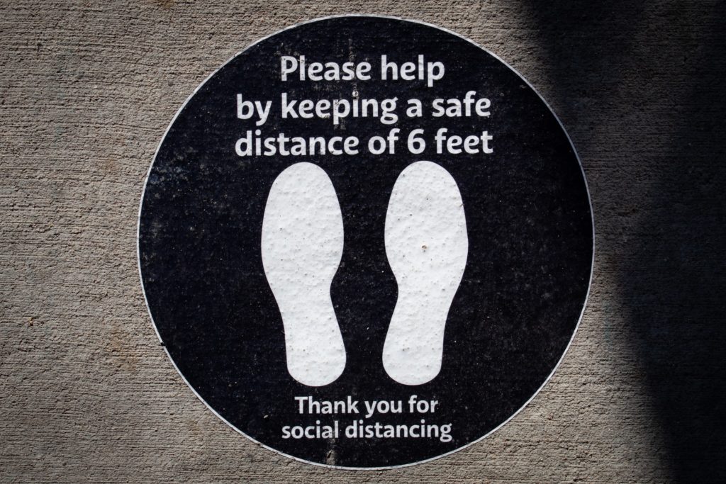 A floor sticker encouraging social distancing in a store
