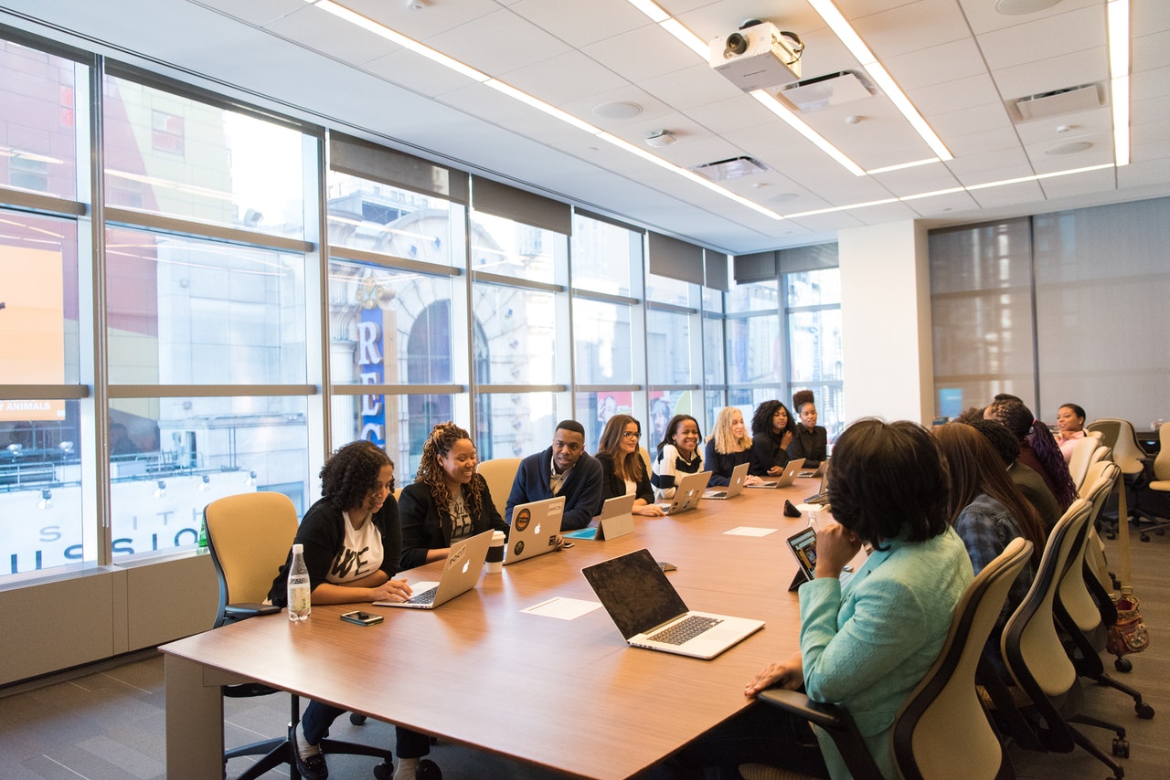 A group of people meeting in a boardroom representing shareholders of a corporation