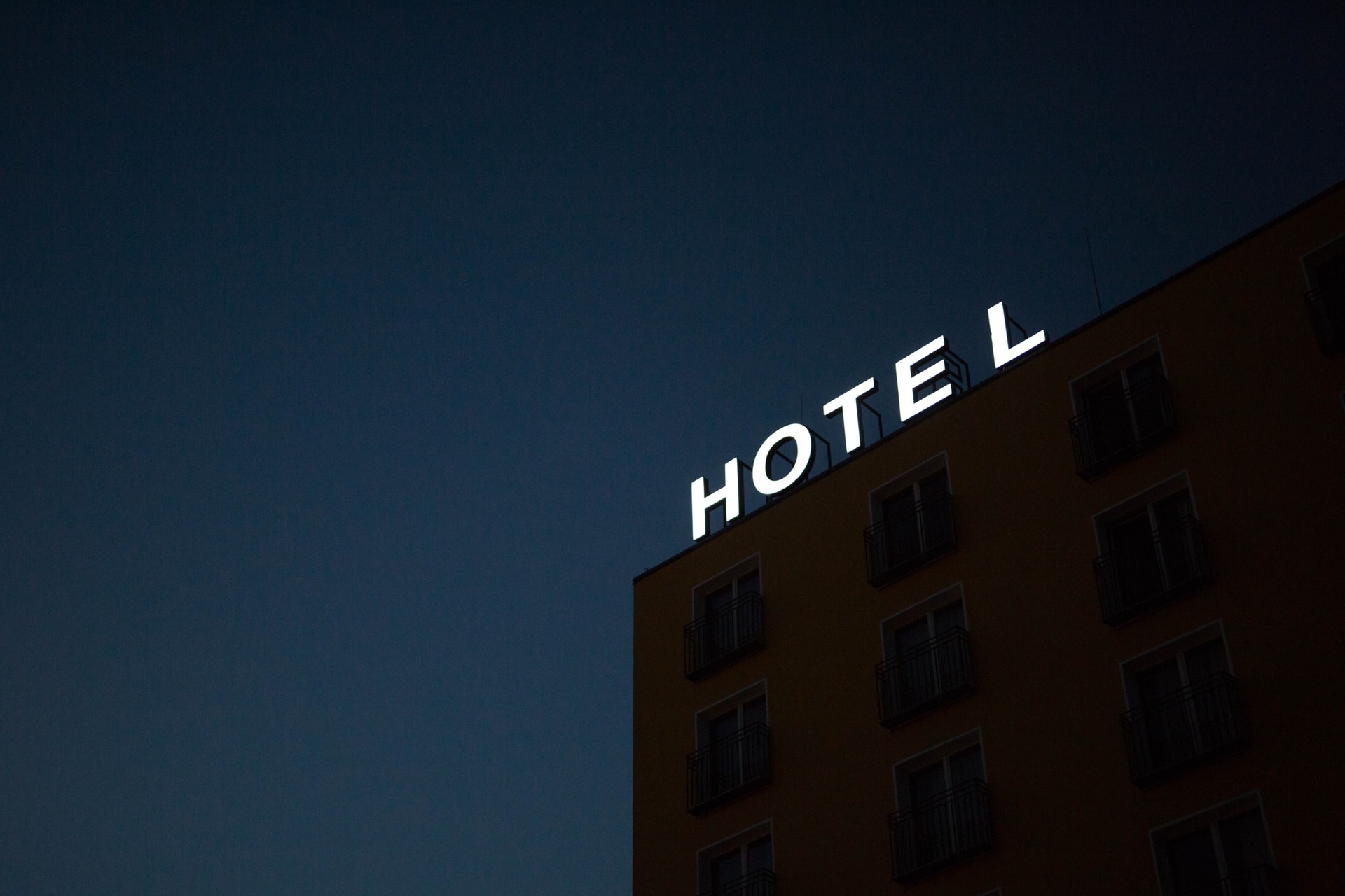 A lit hotel sign representing a motion for an injunction pending a court's decision on mandatory COVID hotel stays for international travellers