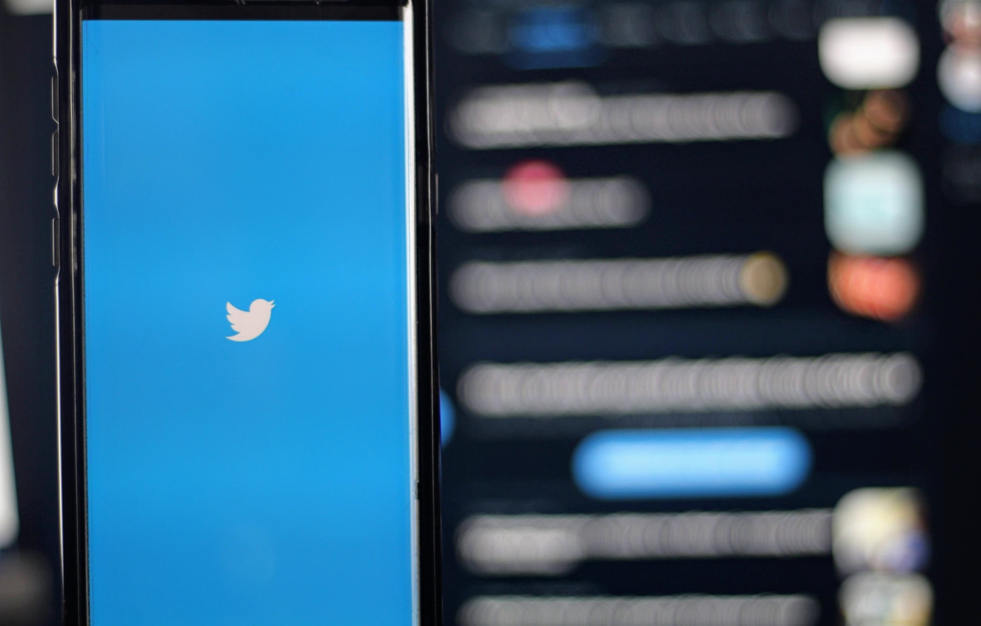 A blurred Twitter screen representing a business suing a person for making negative statements about them on social media