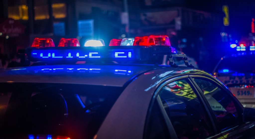 Police lights representing whether criminal charges could be considered material to a life insurance application