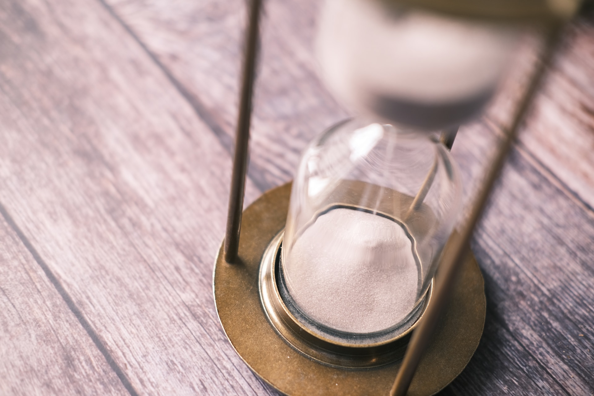 an hourglass sitting on top of a wood table