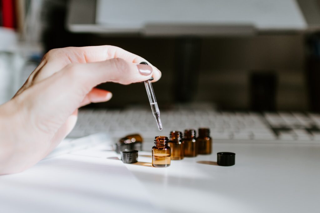 small brown oil bottles and dropper