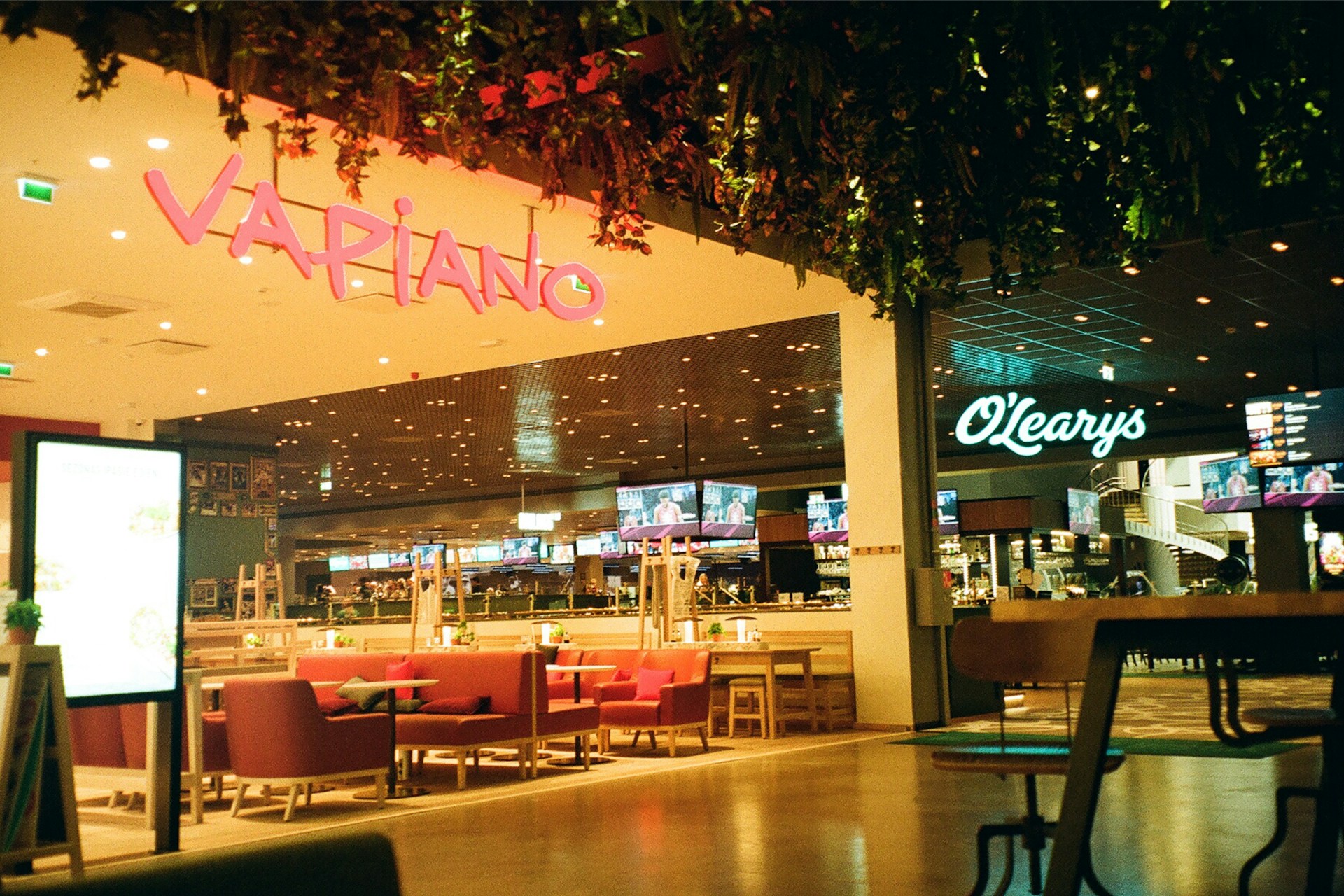 a restaurant with tables in a shopping plaza