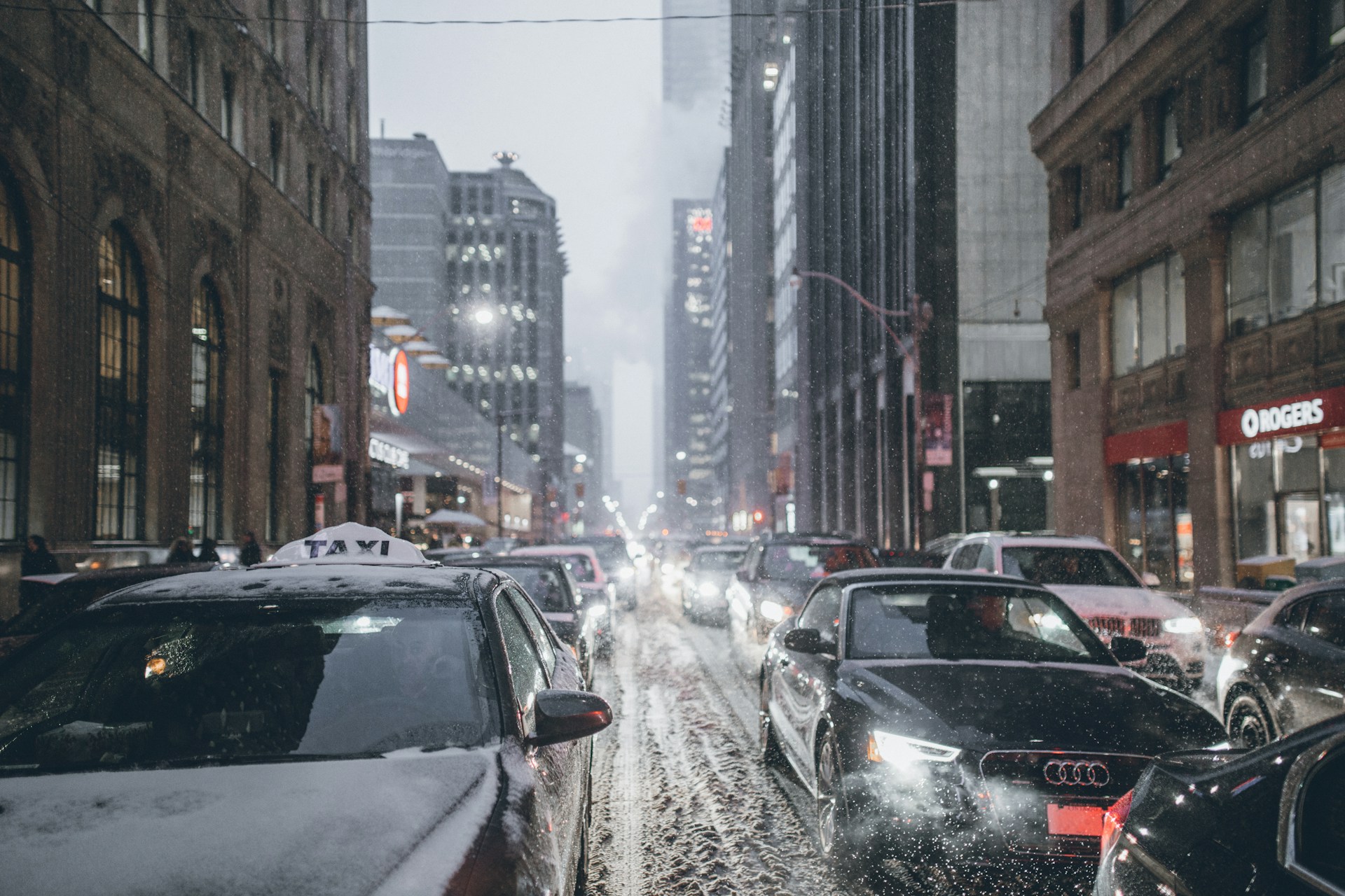 heavy traffic on street in Toronto during snowstorm