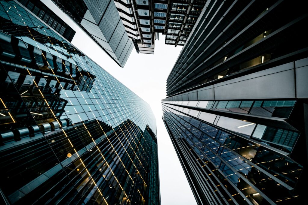 a photo shot that looks directly up at sklyine of office buildings