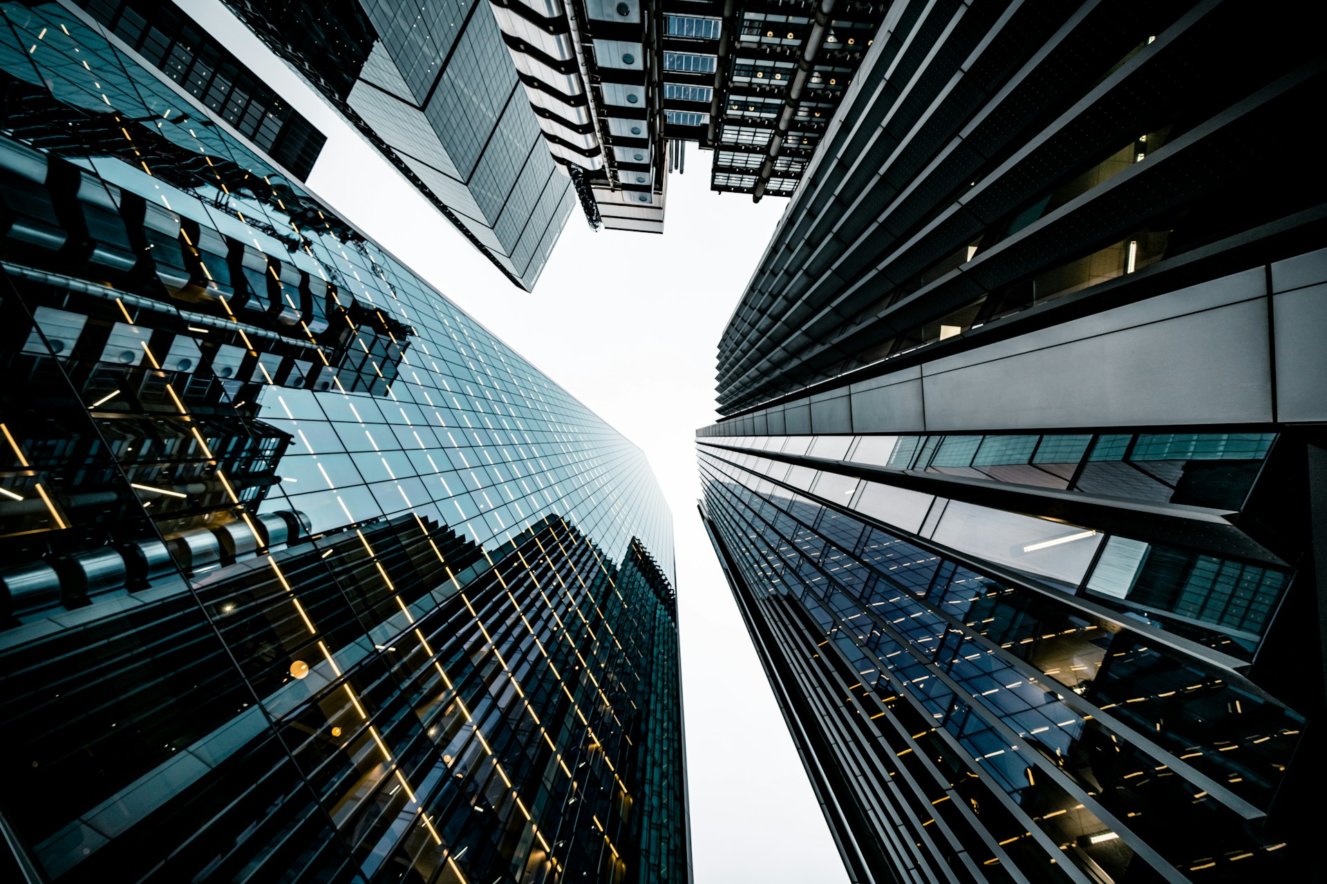 a photo shot that looks directly up at sklyine of office buildings