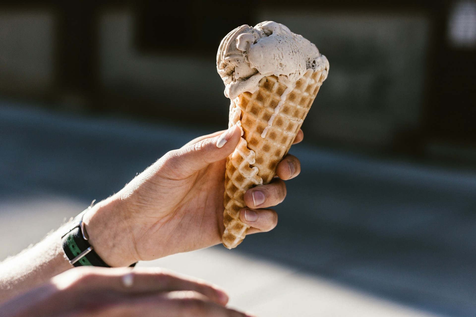 a person holding an ice cream cone
