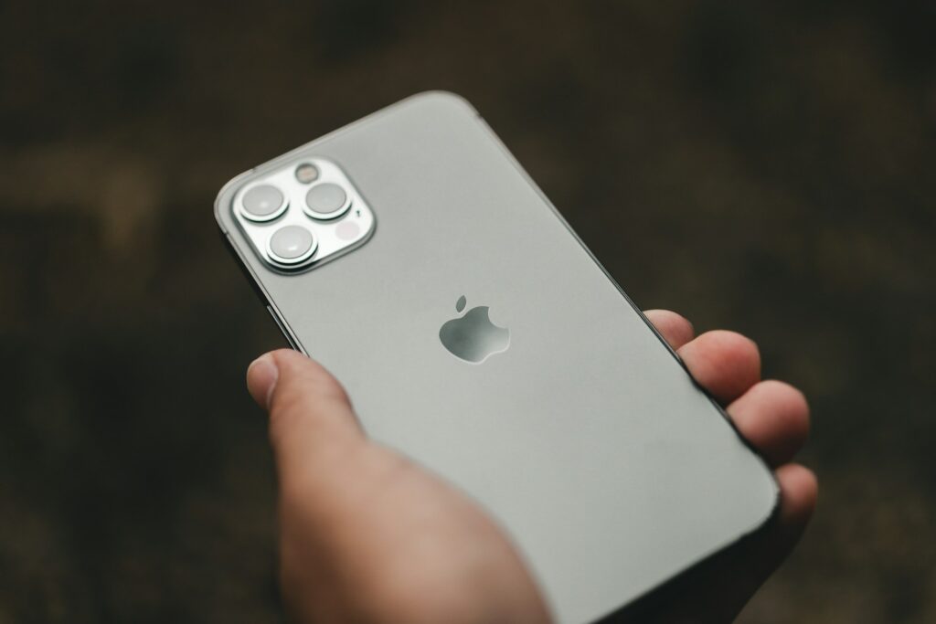 A hand holding an iPhone, representing Civil Contempt.