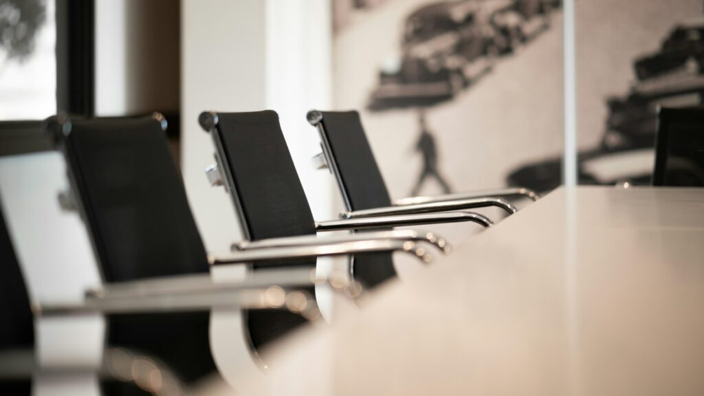 Empty chairs at a conference table, representing shotgun clauses.