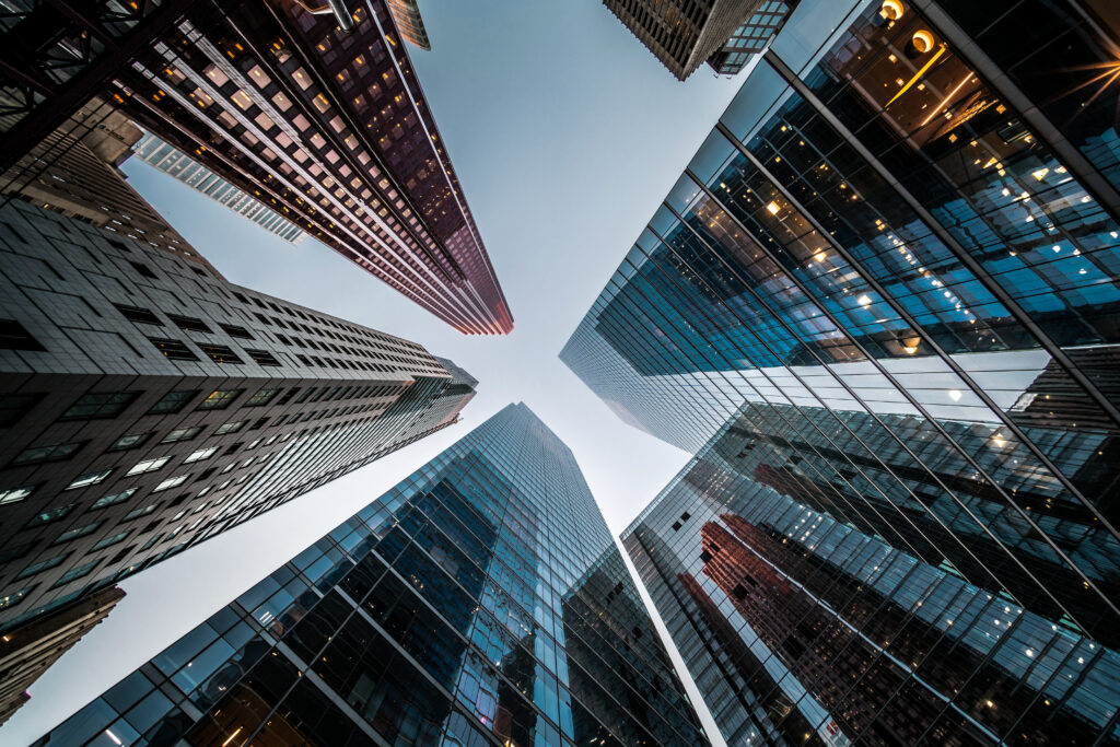 Ground-up view between skyscrapers in downtown Toronto, representing the leading complex commercial and fraud litigation services provided by the litigation lawyers at Milosevic & Associates.