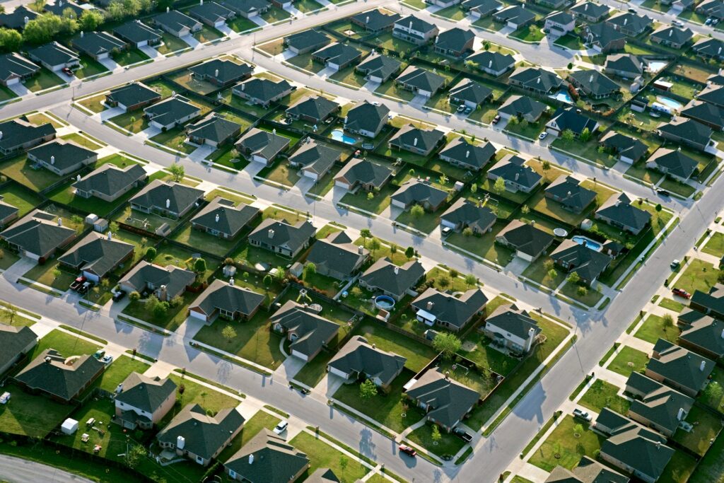 An overhead view of a suburban subdivision, symbolizing receiverships and insurance for fraud victims.