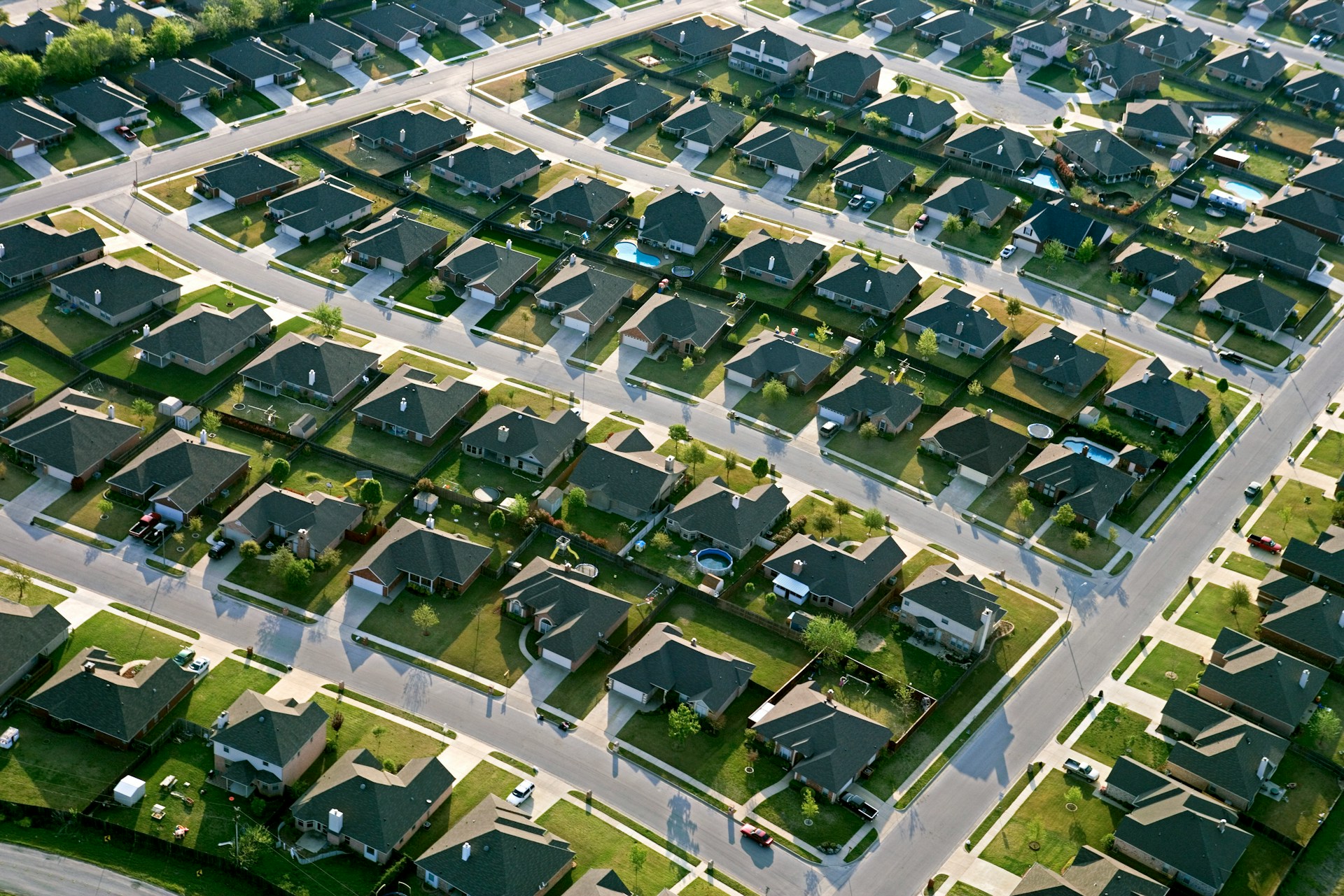 An overhead view of a suburban subdivision, symbolizing receiverships and insurance for fraud victims.