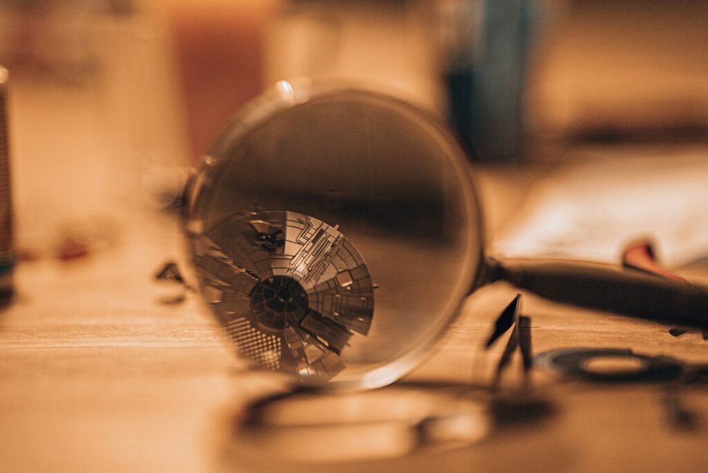 A magnifying glass focusing on intricate details, representing a court-ordered investigation and the appointment of an inspector under the Business Corporations Act.