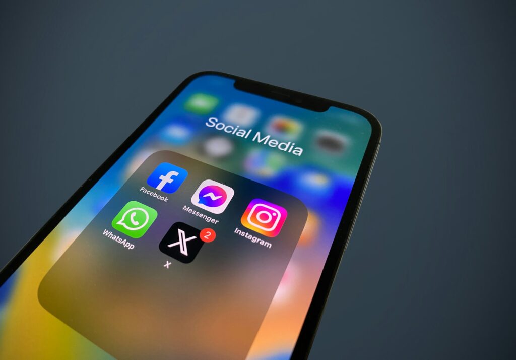 Social media apps on a smartphone, representing defamatory social media posts and broker negligence.