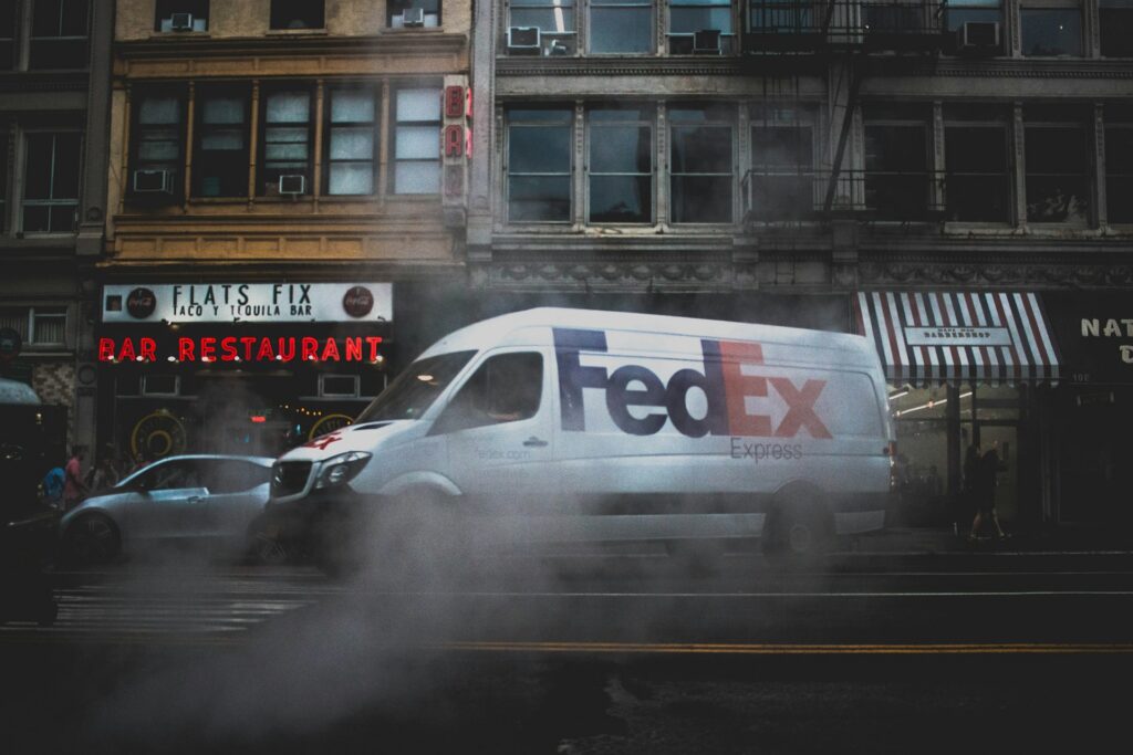A FedEx van on a busy city street with mist drifting across the road, representing Class Proceeding.