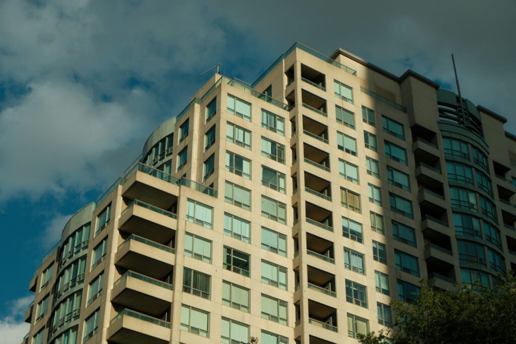 A condominium building set against a blue sky, representing oppression remedies, summary judgments, and liens in commercial real estate disputes in Ontario