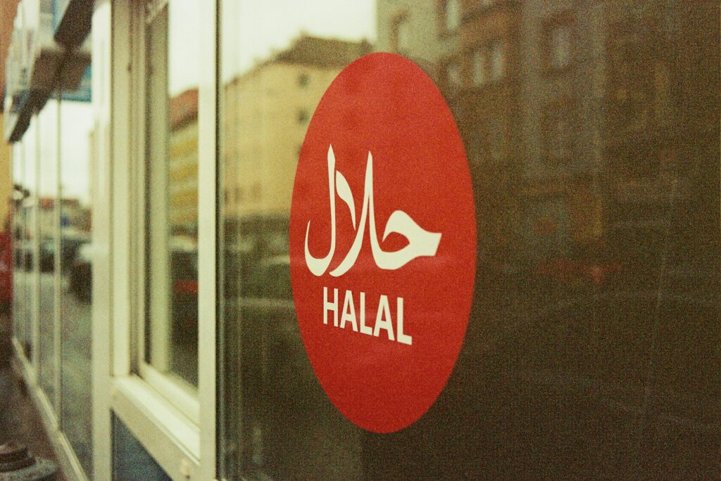 A red Halal sticker on a storefront window, representing the case of Islamic Food and Nutrition Council of Canada v. Islamic Food and Nutrition Council of America and voting rights of non-profit stakeholders in Ontario