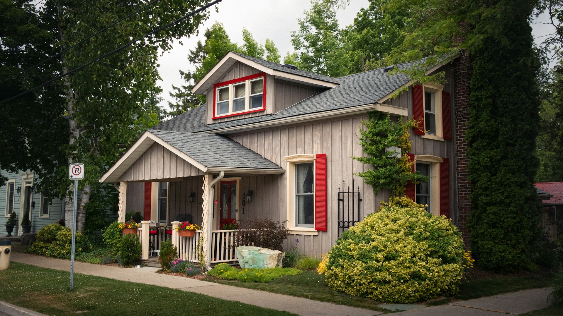 A charming house with red shutters on a tree-lined street, representing real estate disputes, partnership disagreements, and property trusts in Ontario