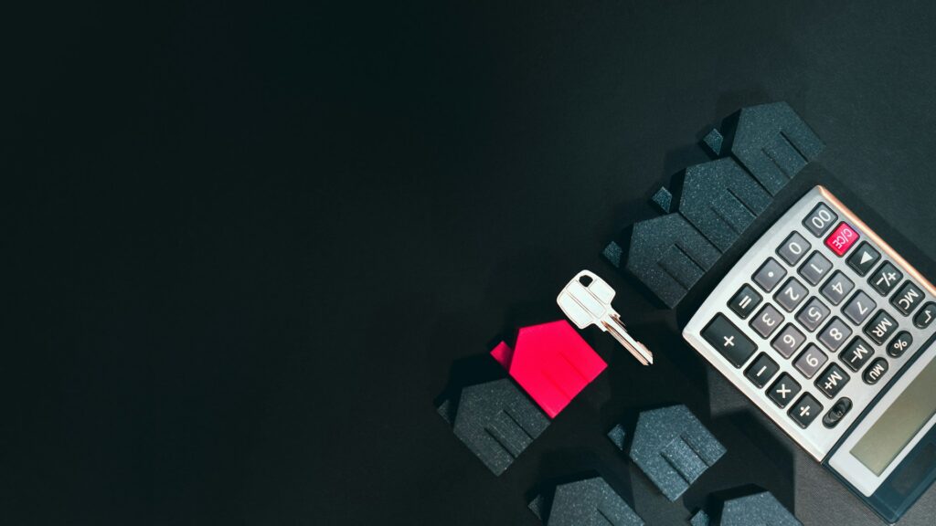 A calculator, house key and home icons with a black background depicting mortgage fraud in Ontario.