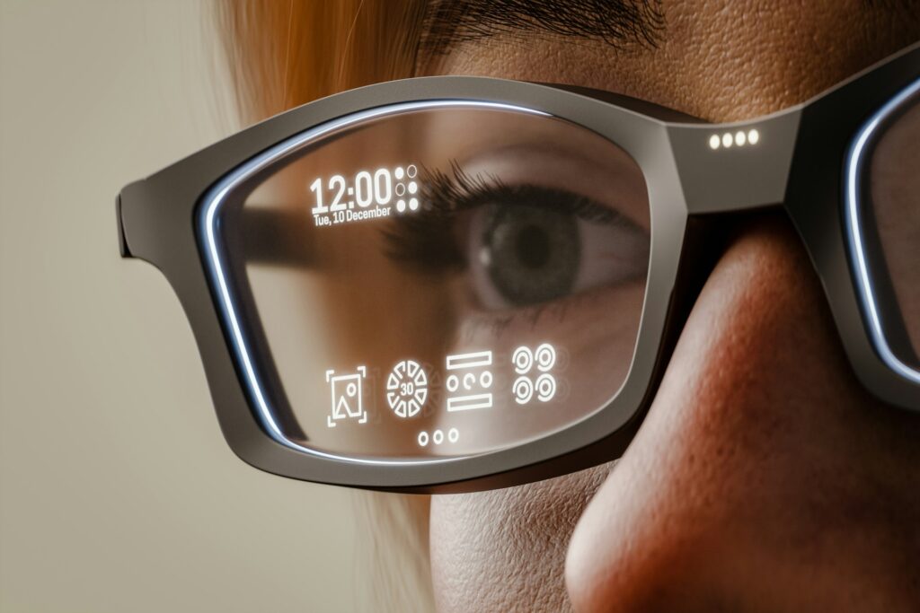 A close up of a person wearing smart glassees, representing AI fraud.
