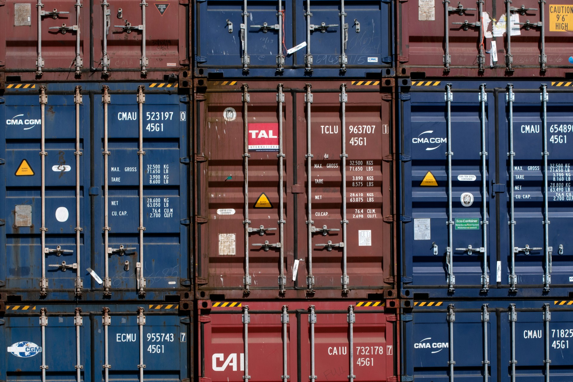 Black and red metal storage containers stacked together represent storage lien disputes in Ontario.
