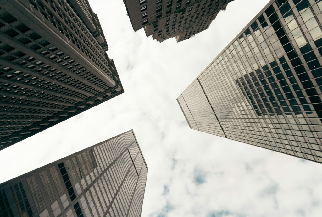 Four office buildings made from cement, glass, and steel stretch up into an overcast sky, representing Ontario judgment enforcement.