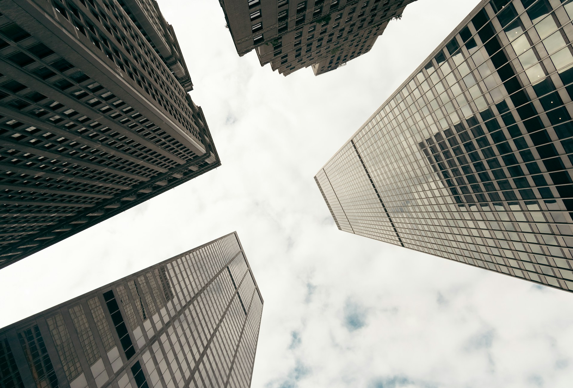 Four office buildings made from cement, glass, and steel stretch up into an overcast sky, representing Ontario judgment enforcement.