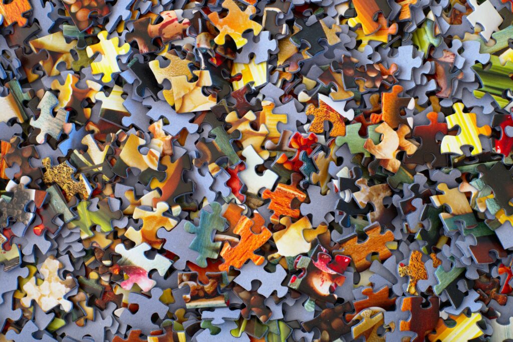A stack of jigsaw puzzle pieces representing how to understand Ontario judgment enforcement works and commercial asset recovery.