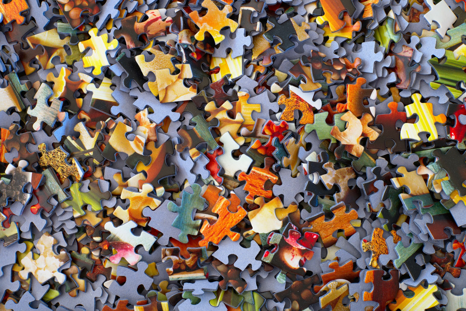 A stack of jigsaw puzzle pieces representing how to understand Ontario judgment enforcement works and commercial asset recovery.
