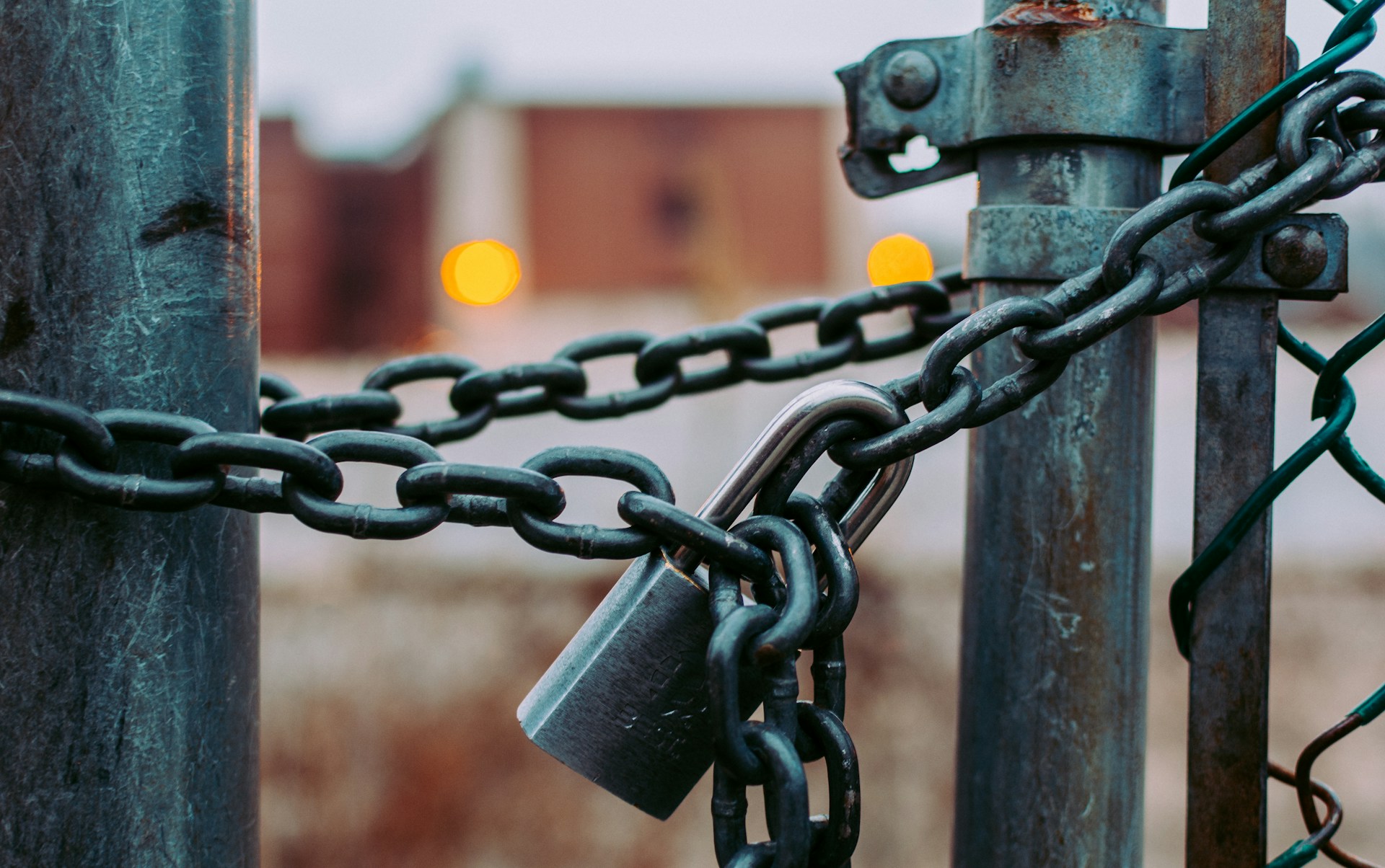 A padlock and chain locking up a business property, representing judgment enforcement against property and business assets in Ontario