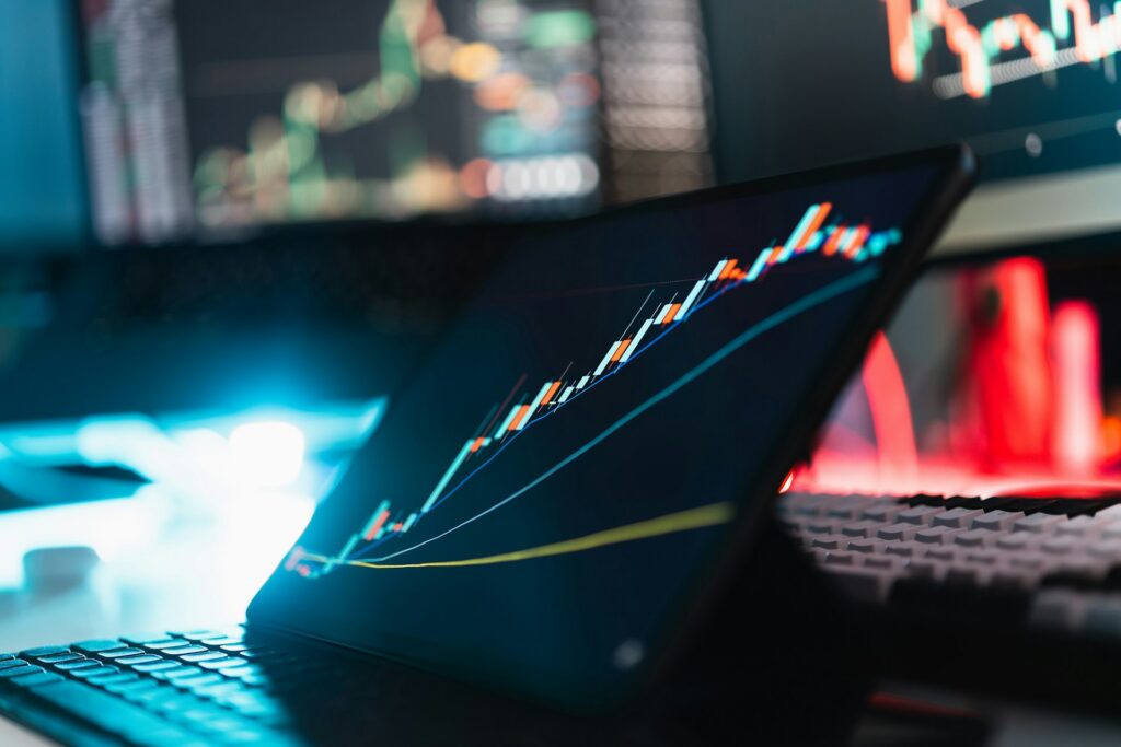 Tablet displaying a stock market graph representing crypto 'rug pulls' in civil claims.